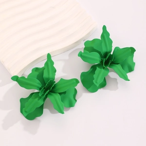 Detailed macro view of matte light green floral earrings with 3D wavy petal structure