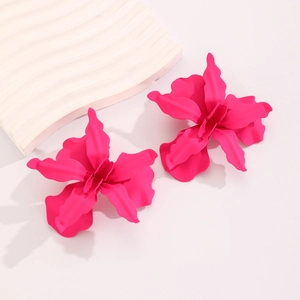 Macro view of matte hot pink geometric pleated flower earrings for fashion party wear