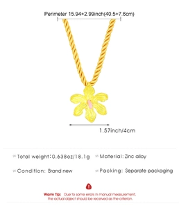 Detailed view of a gold rope chain necklace featuring a yellow and pink floral pendant