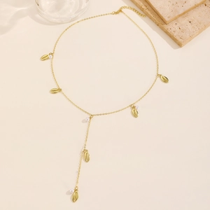 Elegant gold-tone Y-shaped necklace with sea shell pendants and pearls on a light background