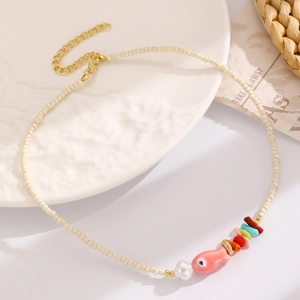 Dettaglio della collana di perline con ciondolo a pesce in ceramica rosa e pietre colorate