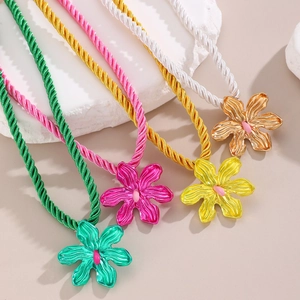Detail of colorful floral pendants with cotton ropes in green, pink, yellow and white