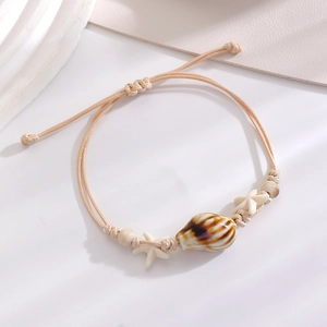 Detail of a handmade ocean-style rope bracelet with starfish beads and shells