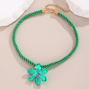 Detail of green floral pendant necklace with woven cotton rope and gold lobster clasp