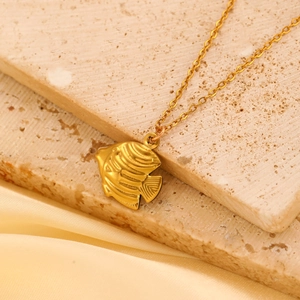 Minimalist gold tropical fish pendant necklace with delicate engraved texture on fine chain