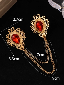 Detailed view of vintage gold-tone double brooch with red crystal drops and measurement