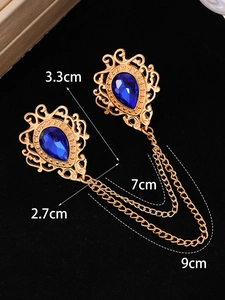Detailed view of vintage crystal brooch with blue gems and golden chain dimensions