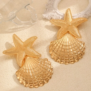 Statement gold starfish and shell dangle earrings with textured and polished finish