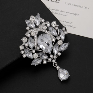 Detailed macro view of vintage silver brooch with teardrop crystals and sparkling rhinestones