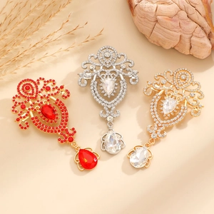 Macro detail of vintage style alloy brooches with colorful rhinestones and pear-shaped gems