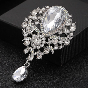 Vintage silver crystal brooch with pear-shaped stone and teardrop pendant on black box
