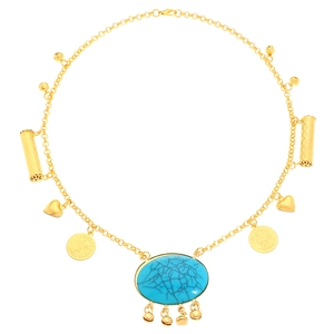 Detail of bohemian gold layered necklace featuring turquoise pendant and coin charms