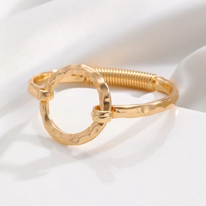 Macro shot of gold-plated hammered ring bangle with elegant metallic texture