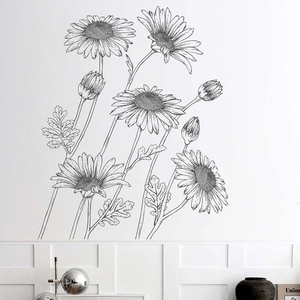 Detail of hand-drawn sunflower wall decals with artistic black and white linework on a white wall