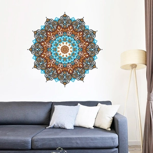Detailed blue bohemian mandala wall decal above a grey sofa in a minimalist living room