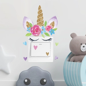 Detail of cartoon unicorn light switch wall sticker with glitter horn and flower decals