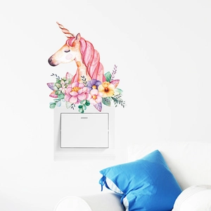 Detailed watercolor unicorn wall sticker applied above a white light switch on a home wall