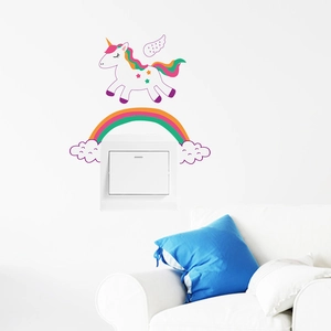 Close-up of colorful unicorn and rainbow wall sticker applied above a light switch
