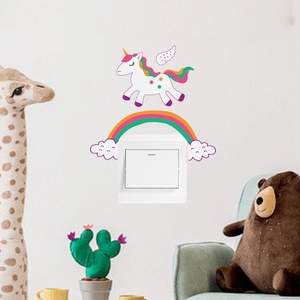 Creative cartoon unicorn and rainbow wall sticker decorating a white light switch in a nursery
