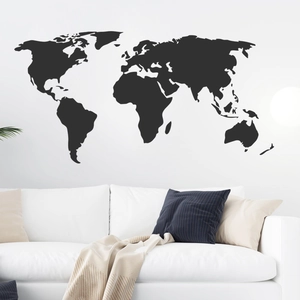 Minimalist world map wall decal in black vinyl displayed over a modern living room sofa