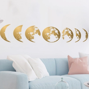 Set of 7 gold moon phase wall decals showing textured lunar cycle over a blue sofa