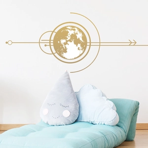 Minimalist golden earth and moon wall decal art in a modern bedroom setting