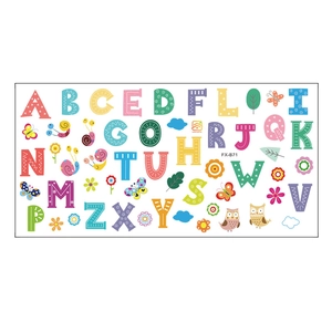 Flat lay of 26 English alphabet wall decals with cute cartoon owls and floral elements
