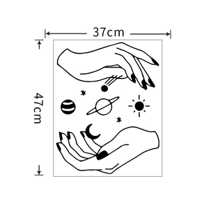 Detailed black and white wall sticker showing hands holding planets and celestial stars