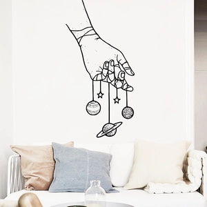 Minimalist black and white wall sticker featuring hand silhouette and cosmic planets design