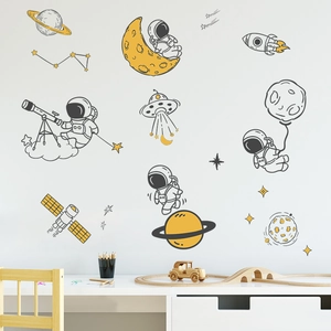 Detailed view of astronaut and rocket wall decals on a cozy kid room wall