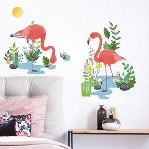 Detail of pink flamingo and tropical plant wall stickers on a clean white bedroom wall