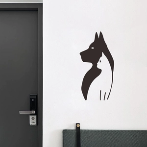 Minimalist wall decal showing black dog silhouette and white cat line art on a white wall
