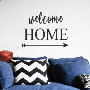 Detail showing welcome HOME wall sticker with arrow above a blue sofa in modern living room