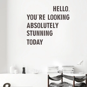 Minimalist black vinyl wall decal with 'Hello You're Looking Stunning' lettering for decor