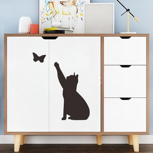Minimalist black cat and butterfly wall decal on a modern wooden dresser for home decor