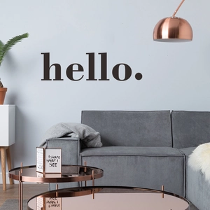 Modern black hello greeting wall decal sticker above gray sofa in minimalist living room