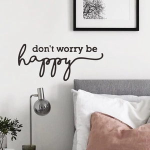 Sticker mural inspirant Don't Worry Be Happy au-dessus du cadre de lit de chambre