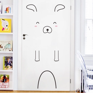 Minimalist animal wall sticker with cute cartoon face on a white bedroom door decor