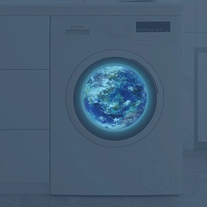 Luminous blue earth wall sticker glowing on a washing machine door in the dark
