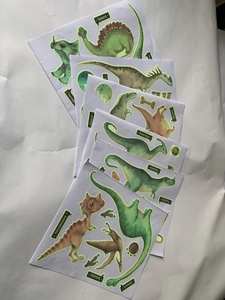 Luminous dinosaur wall stickers set featuring various glow in the dark cartoon decals