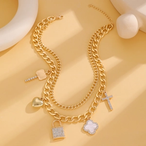 Detailed macro view of gold layered punk chain with rhinestone lock and heart pendants