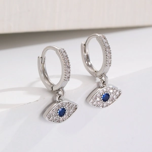 Detailed close-up of evil eye hoop earrings with blue stones and cubic zirconia