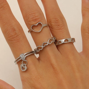 Macro detail of a silver heart ring set showing four unique designs for women