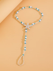 Close-up of bohemian beaded anklet featuring a rhinestone starfish charm and turquoise beads