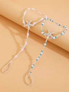 Detail view of starfish barefoot sandals with white pearls and blue beads for beach wear