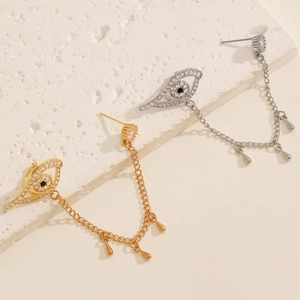Macro detail of Evil Eye ear cuff with zirconia tassel and small metal teardrop pendants