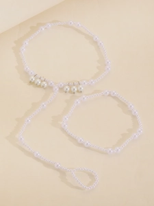 Detailed view of white pearl body chain and bracelet set for beach party jewelry