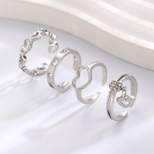 Set of 4 silver heart rings with hollow patterns and zircon charms in open design