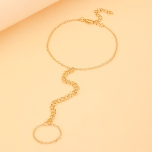 Detail of a bohemian gold-plated ring bracelet with a lobster clasp and curb chain design