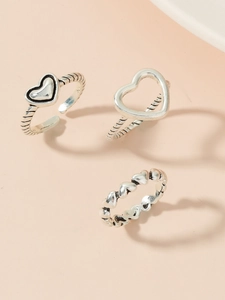 Three-piece silver heart ring set with cutout and solid patterns for a trendy look